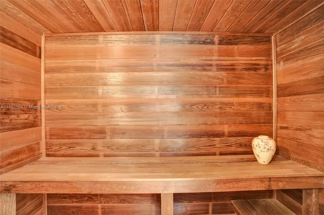 a view of a house with a big yard and palm trees