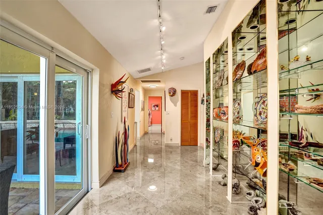 a view of a patio with a table and chairs under an umbrella