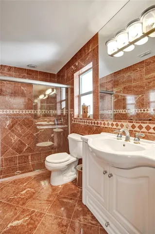 an aerial view of residential house with outdoor space and trees all around