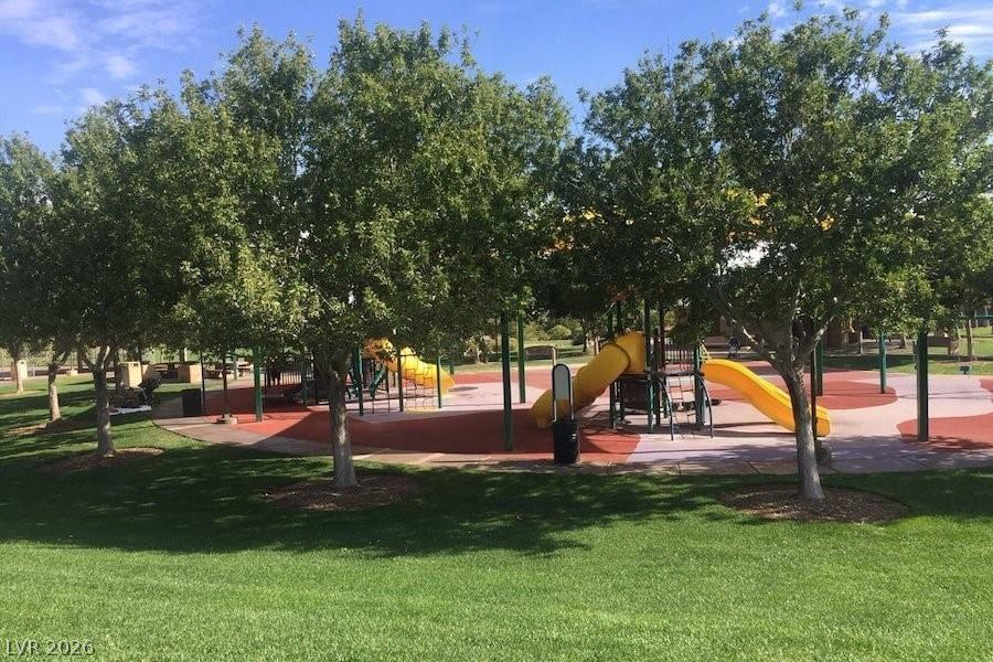 1140 Julie Road Henderson, NV 89002 - Photo 30 of 38 Kids love this vibrant playground featuring slides and ample space for active play.