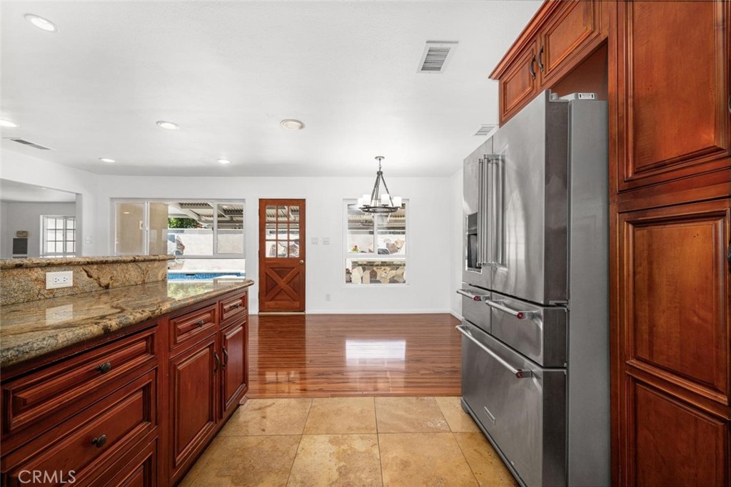 1238 North Studebaker Road Long Beach, CA 90815 - Photo 13 of 47 a kitchen with stainless steel appliances granite countertop a refrigerator and a sink