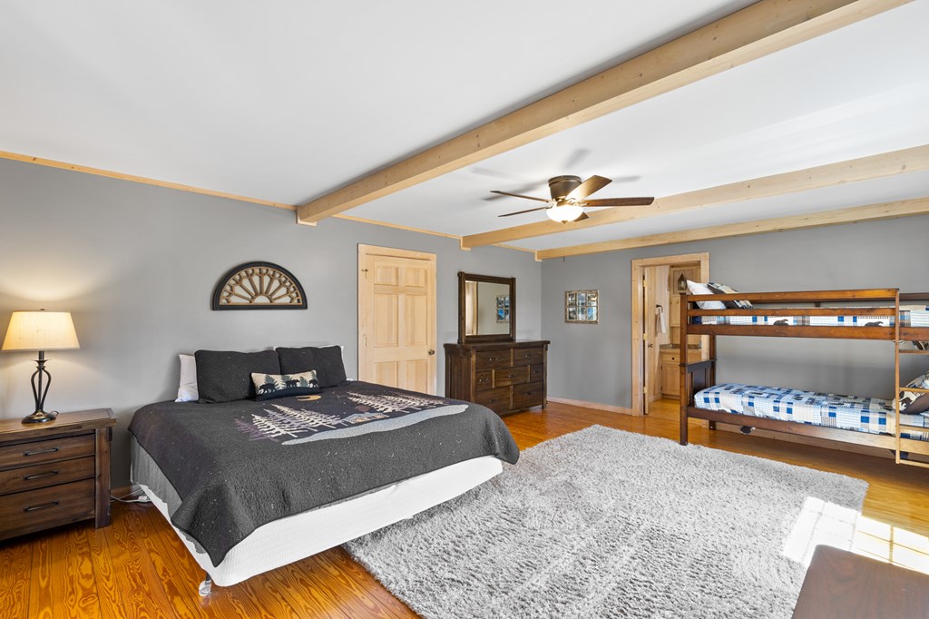 464 Twin Creeks Blue Ridge, GA 30513 - Photo 29 of 61 a bedroom with a large bed and a chandelier
