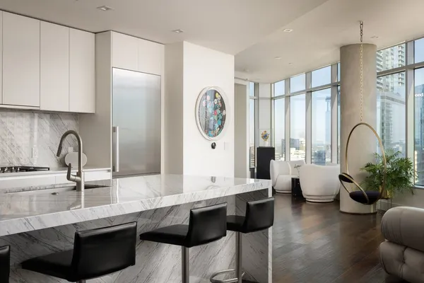 a kitchen with granite countertop white cabinets and black appliances