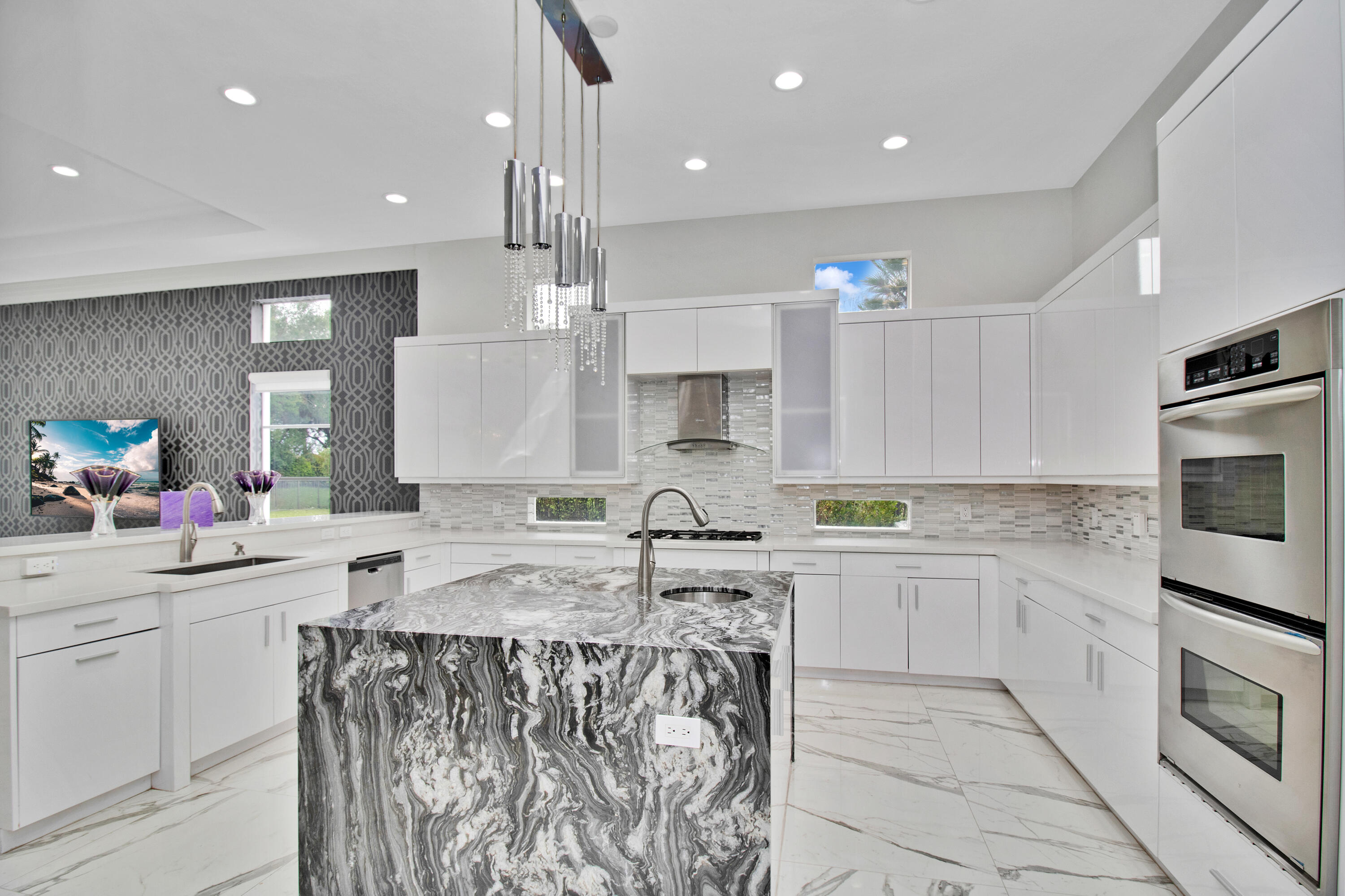 17729 Middlebrook Way Boca Raton, FL 33496 - Photo 31 of 88 a kitchen with kitchen island granite countertop a sink counter top space appliances and cabinets