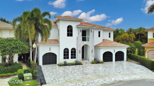 17729 Middlebrook Way Boca Raton, FL 33496 - Photo 10 of 88 a view of a white house with large windows and a large tree