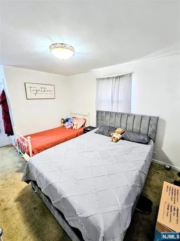 a bed sitting in a bedroom next to a window