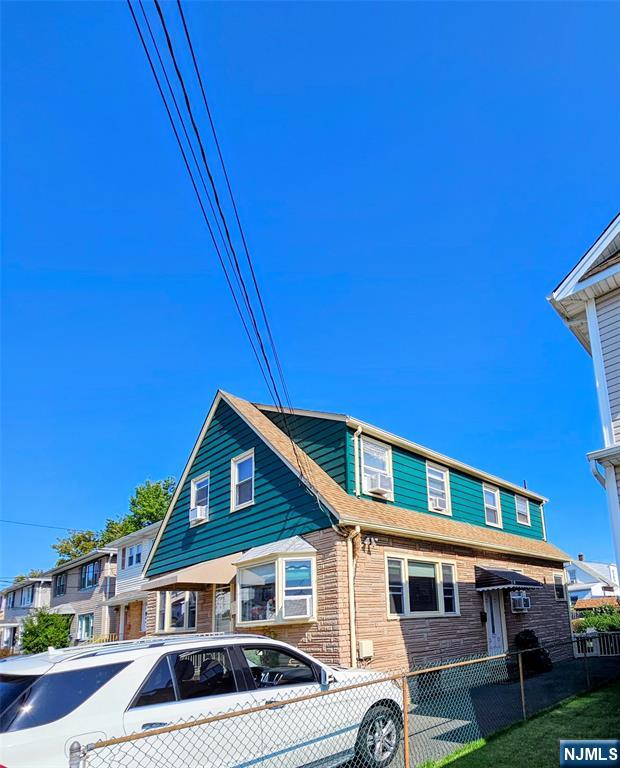 72 Front Street, Unit 2 North Arlington, NJ 07031 - Photo 2 of 14 a front view of a house with a yard