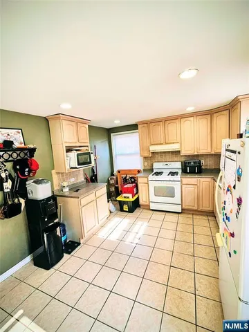 a kitchen with stainless steel appliances a sink counter top space and cabinets