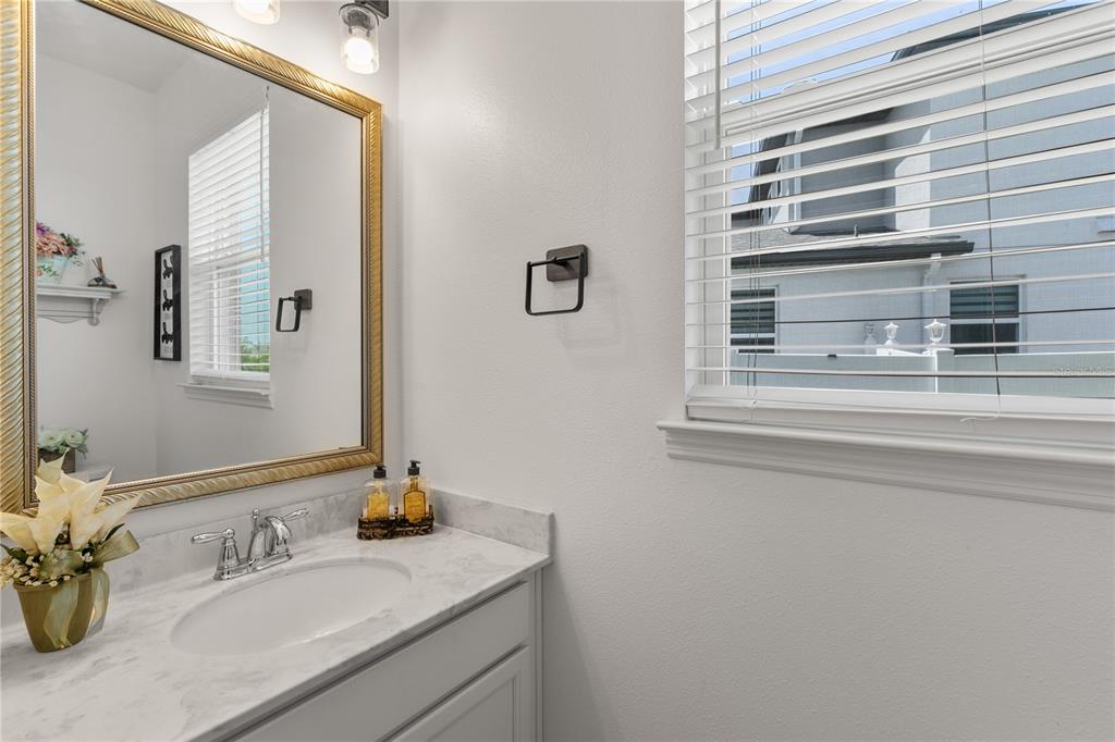 5637 Beggs Road St. Cloud, FL 34771 - Photo 23 of 35 a bathroom with a sink and a mirror