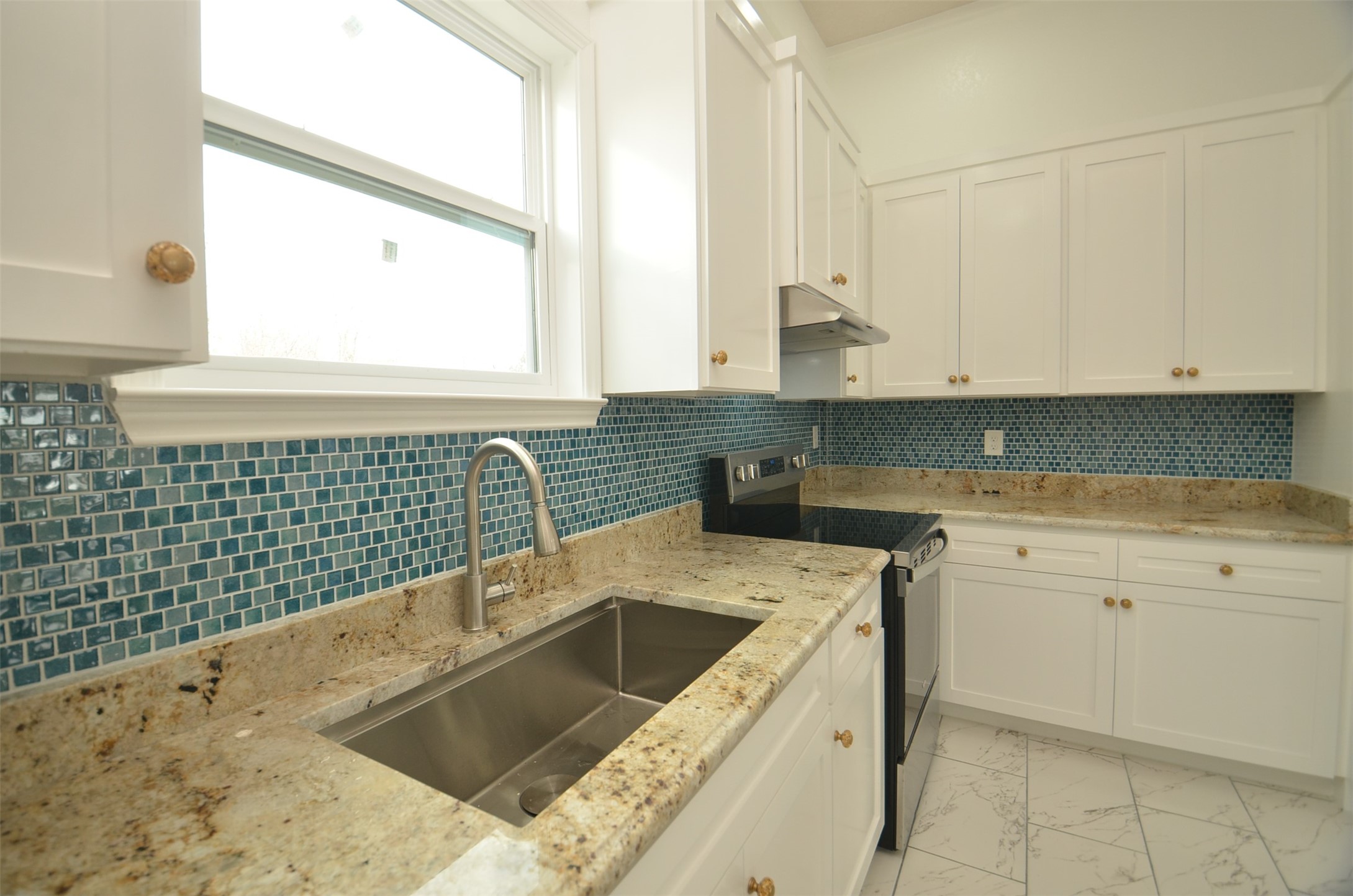 2002 West Airline County Road 55 Rosharon, TX 77583 - Photo 12 of 23 a kitchen with a sink dishwasher a stove and white cabinets with wooden floor