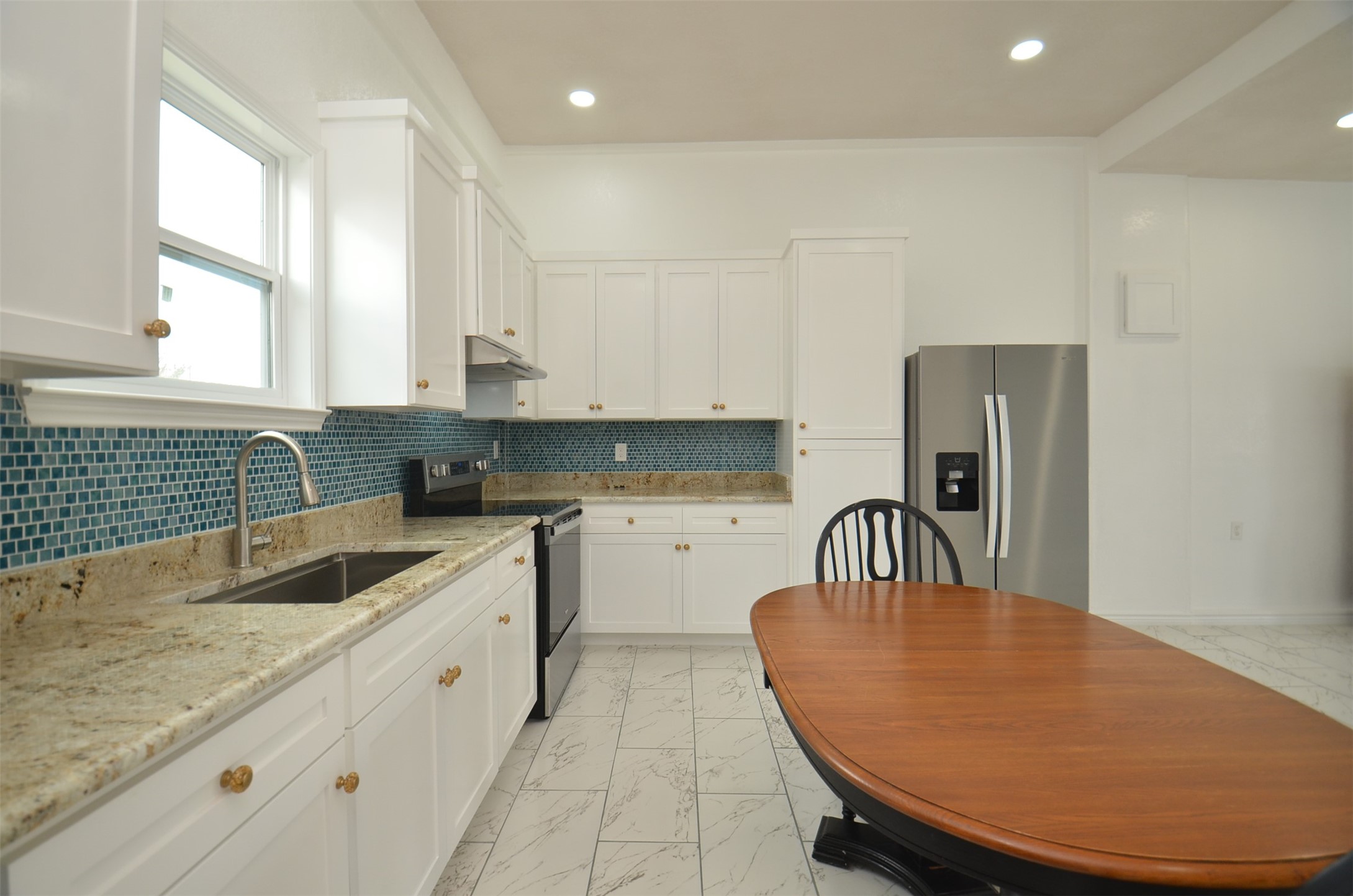 2002 West Airline County Road 55 Rosharon, TX 77583 - Photo 13 of 23 a kitchen with stainless steel appliances granite countertop a sink a stove a refrigerator a counter top space and cabinets