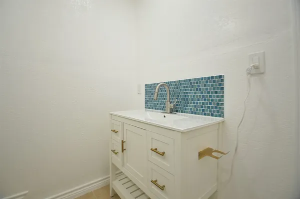 a bathroom with a sink a shower and a mirror