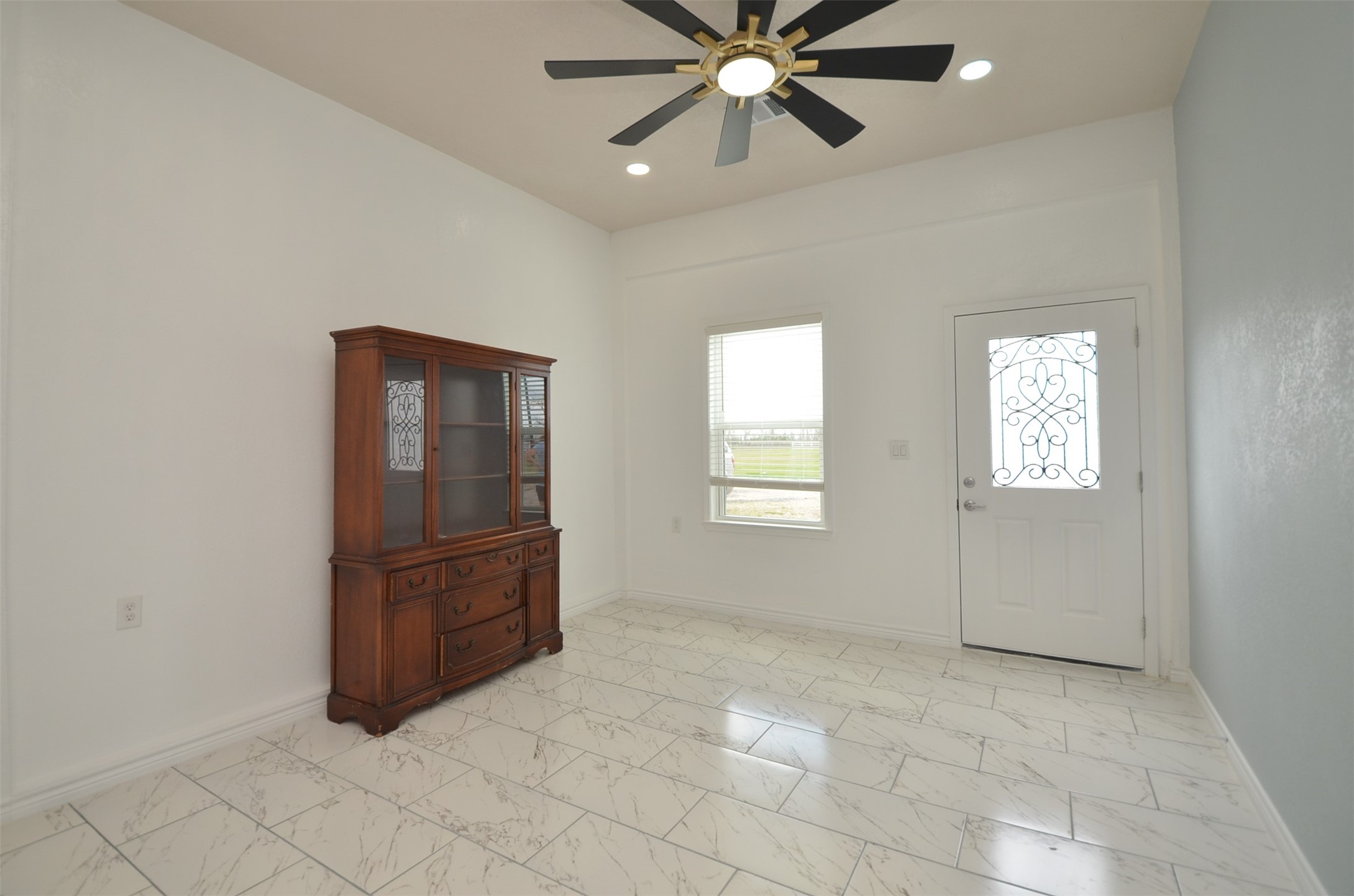 2002 West Airline County Road 55 Rosharon, TX 77583 - Photo 6 of 23 an empty room with windows and fan