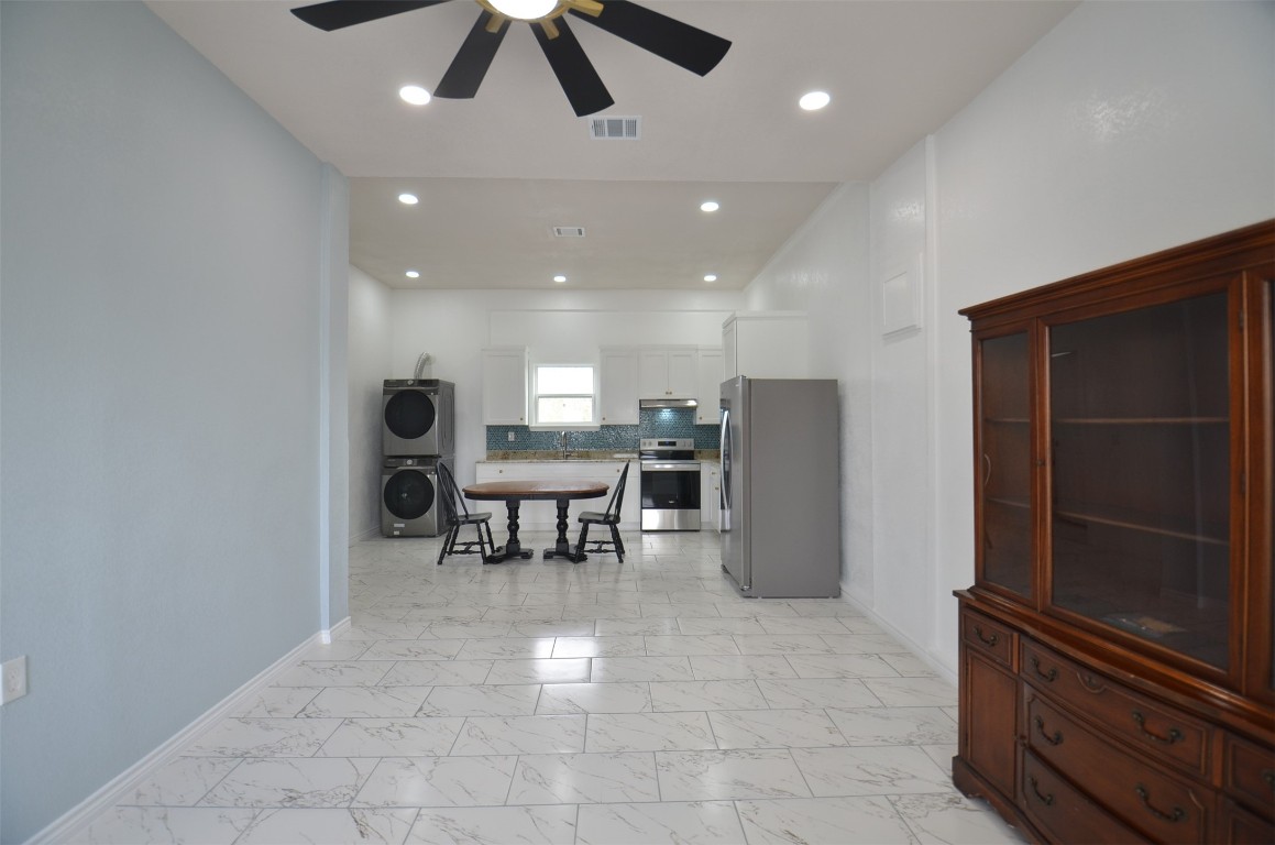 2002 West Airline County Road 55 Rosharon, TX 77583 - Photo 23 of 23 a view of a hallway with chairs and a refrigerator