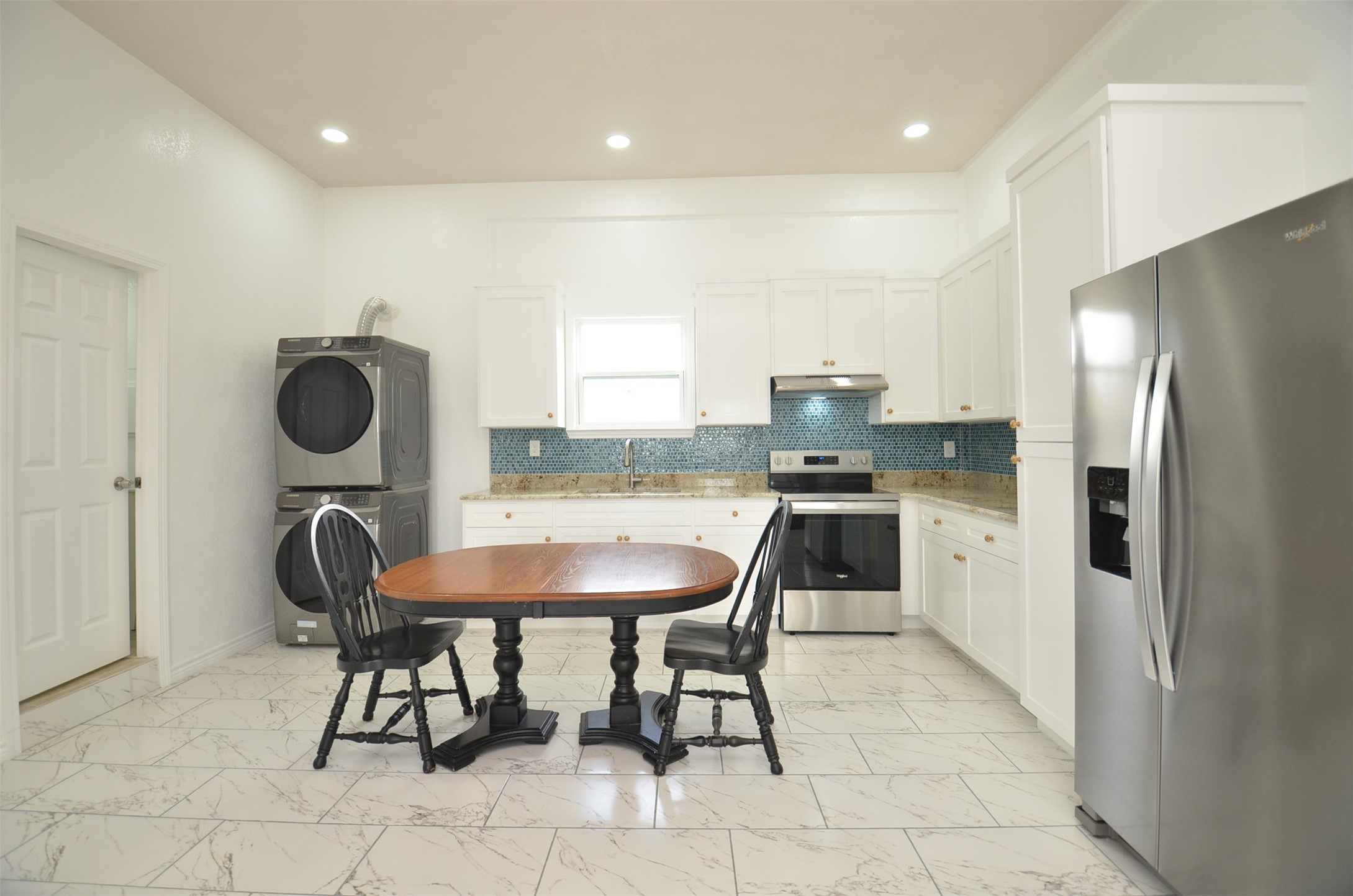 2002 West Airline County Road 55 Rosharon, TX 77583 - Photo 9 of 23 a kitchen with kitchen island a dining table chairs and a refrigerator