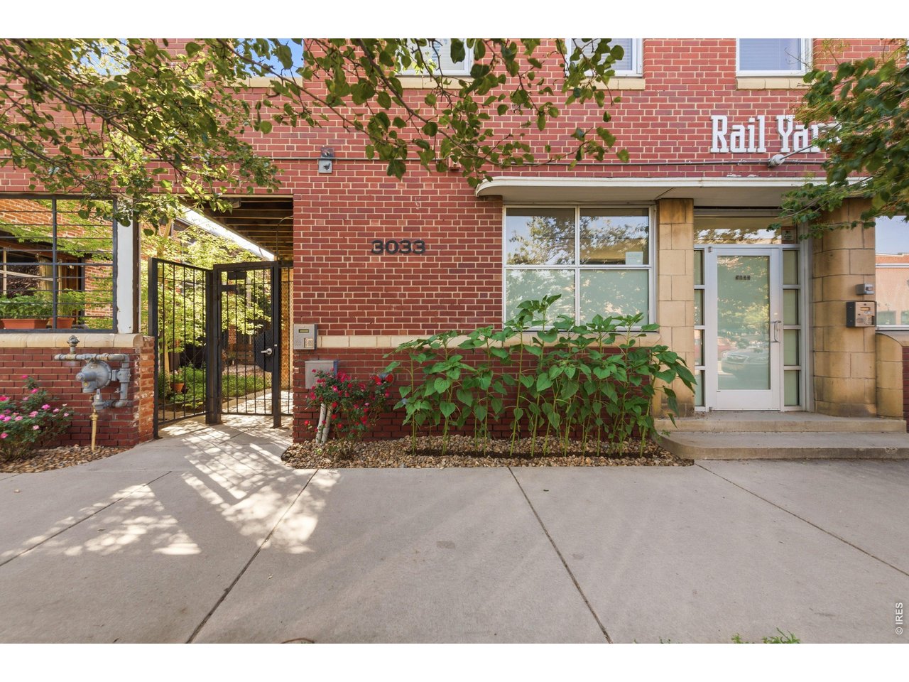 3033 Blake Street, Unit 112 Denver, CO 80205 - Photo 5 of 28 a view of a brick building with a large window