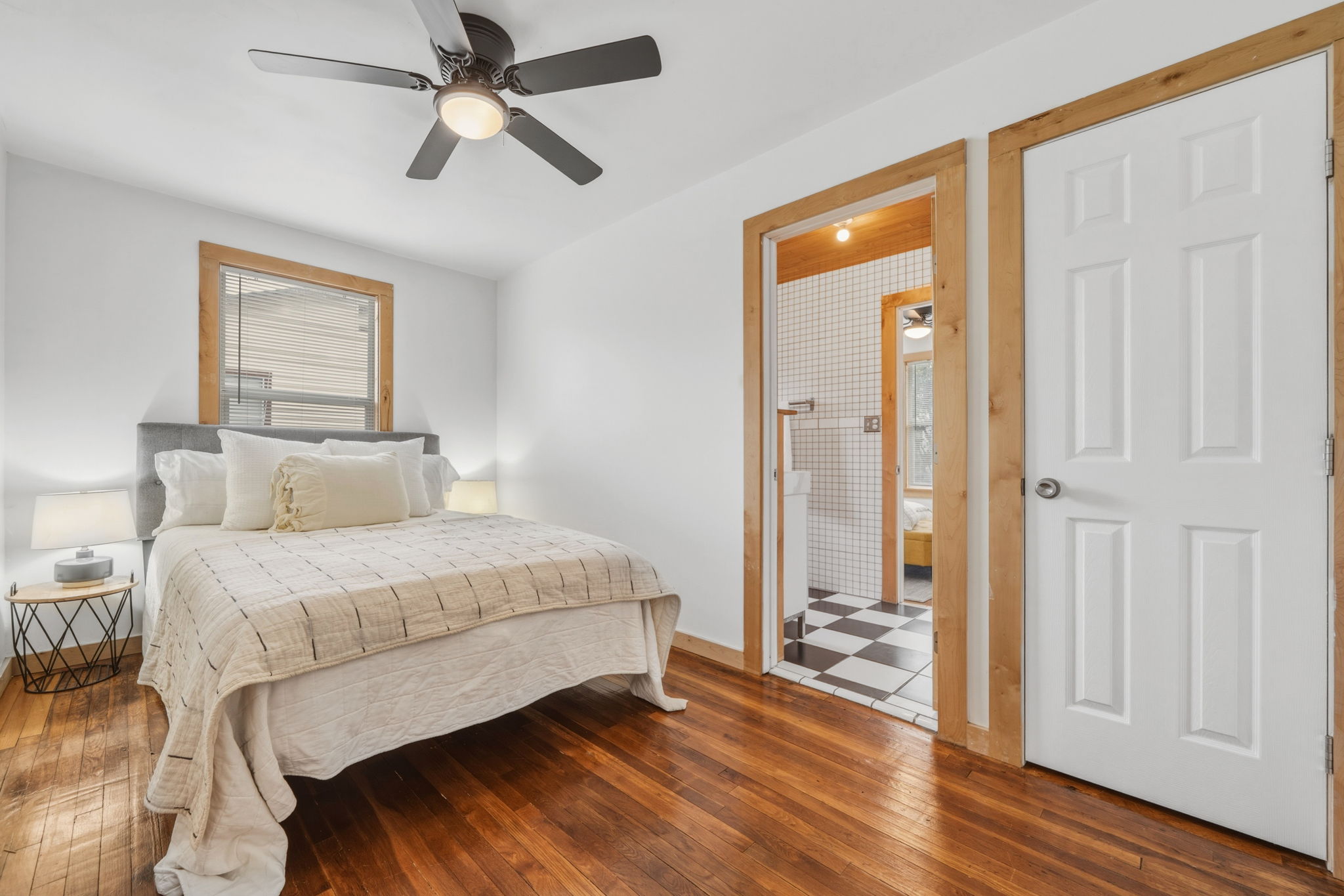 4806 Santa Anna Street Austin, TX 78721 - Photo 16 of 35 a bedroom with a bed and a chandelier