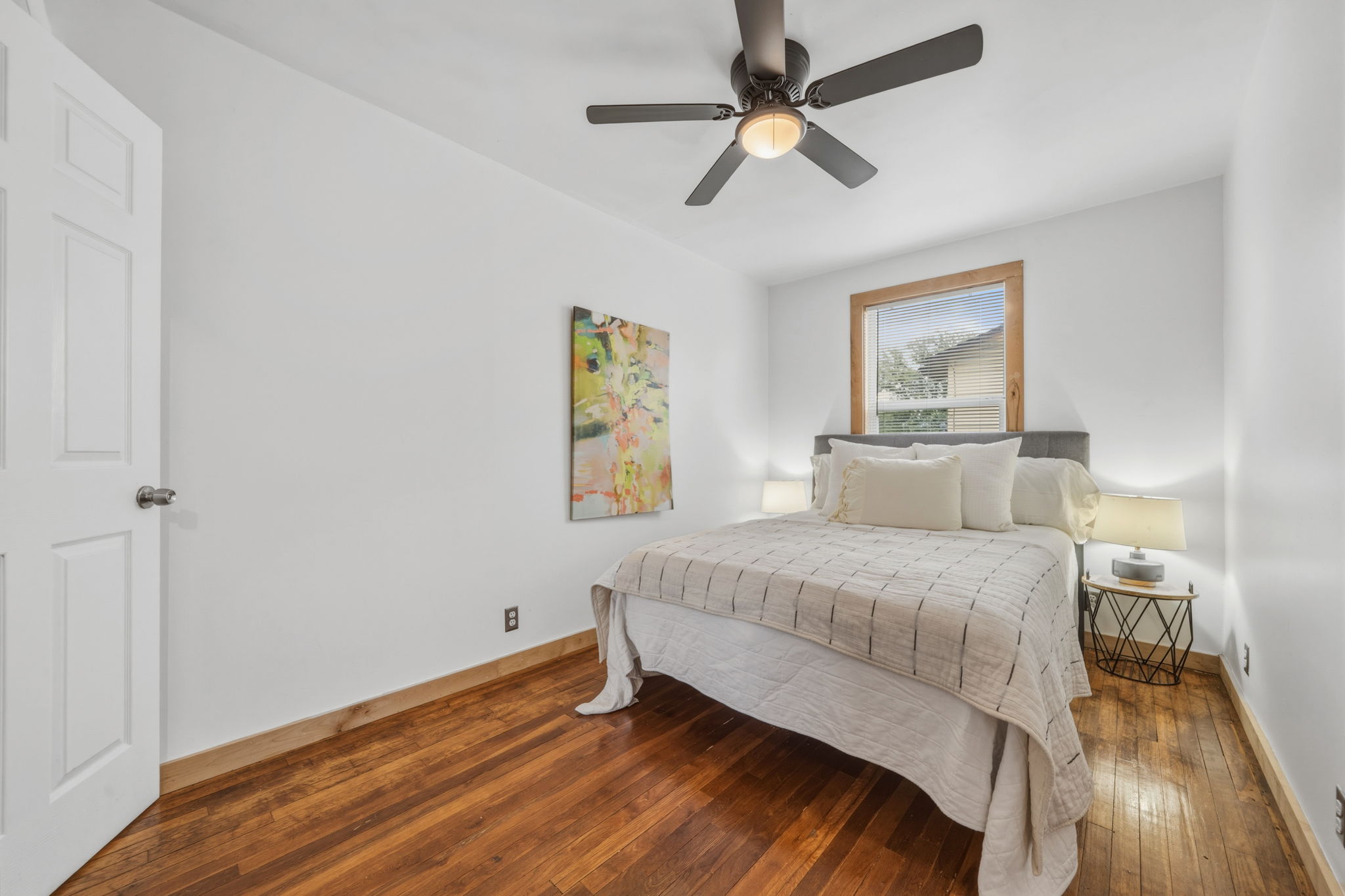 4806 Santa Anna Street Austin, TX 78721 - Photo 17 of 35 a bedroom with a bed and wooden floor