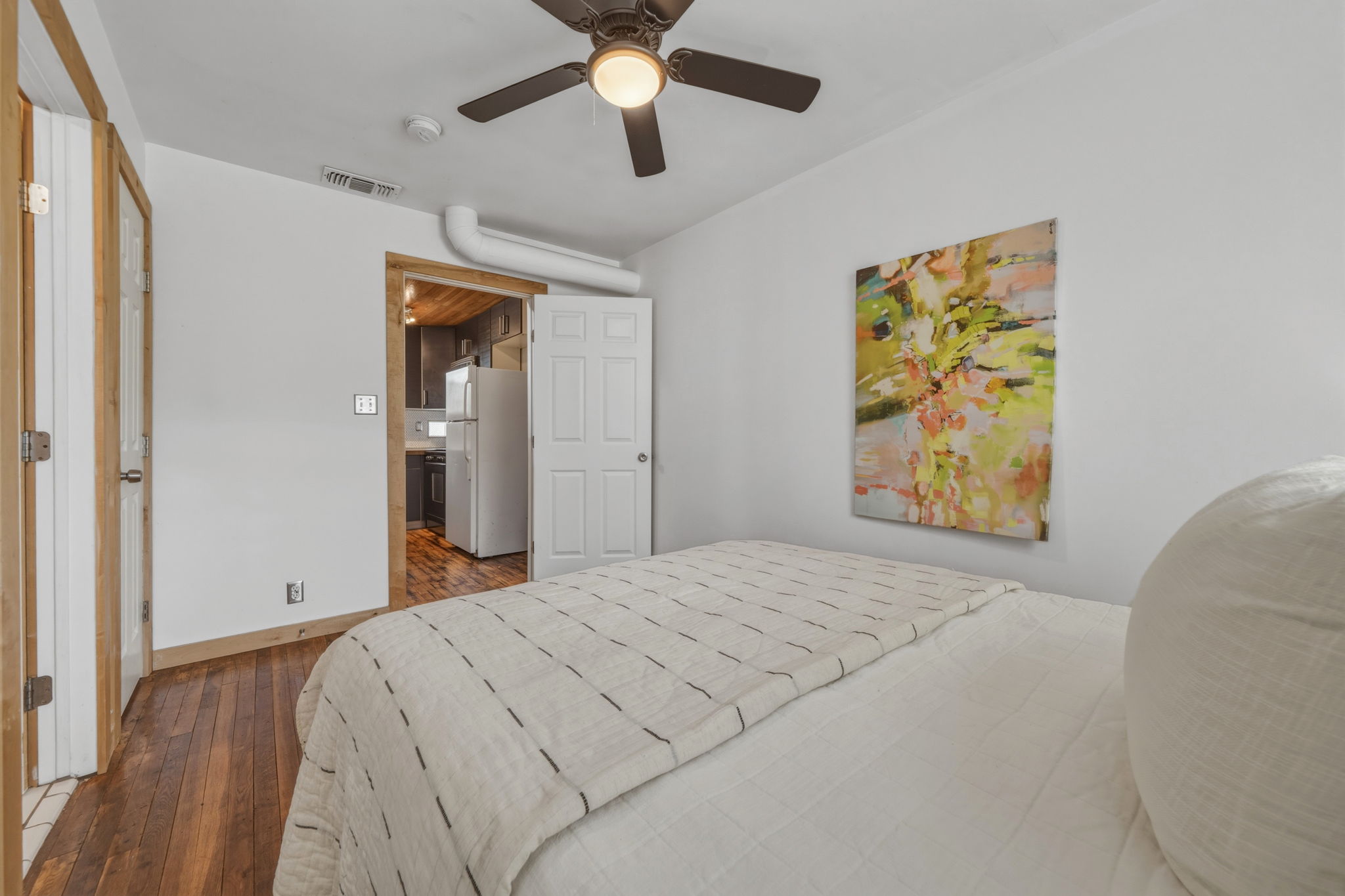 4806 Santa Anna Street Austin, TX 78721 - Photo 18 of 35 a bedroom with a bed and a painting on the wall
