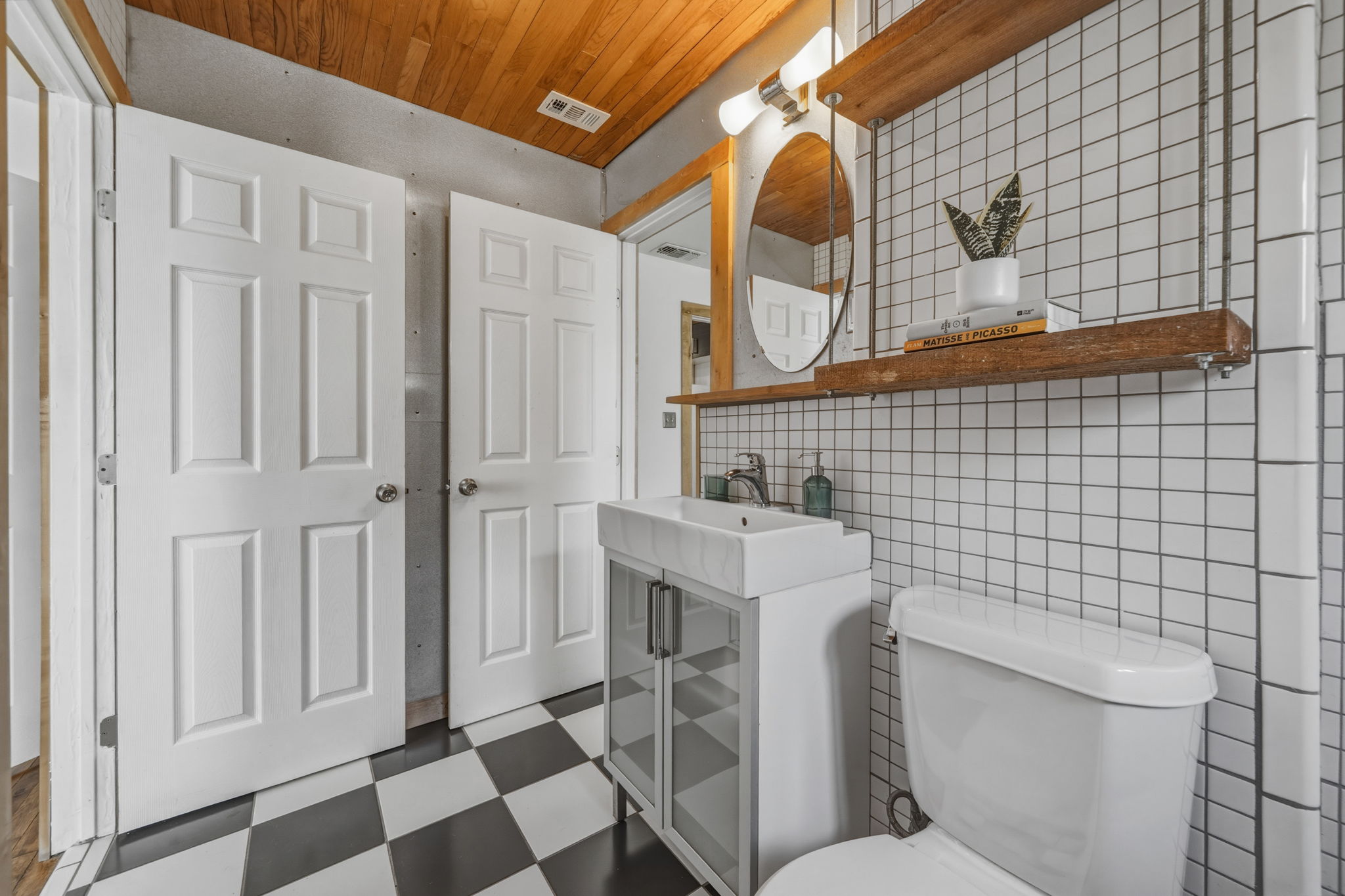 4806 Santa Anna Street Austin, TX 78721 - Photo 21 of 35 a bathroom with a sink a toilet and a mirror