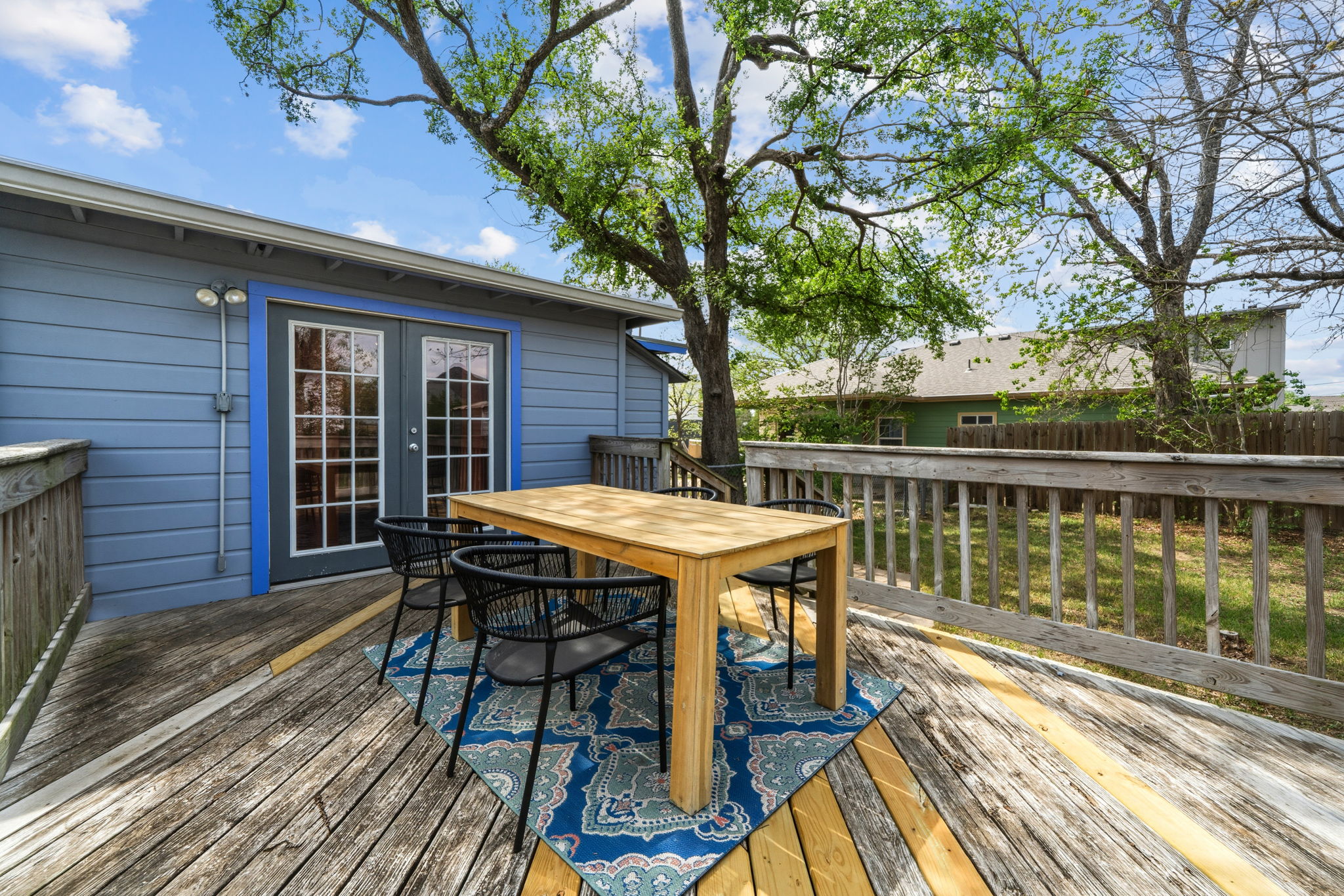 4806 Santa Anna Street Austin, TX 78721 - Photo 31 of 35 a patio with wooden floor table and chairs