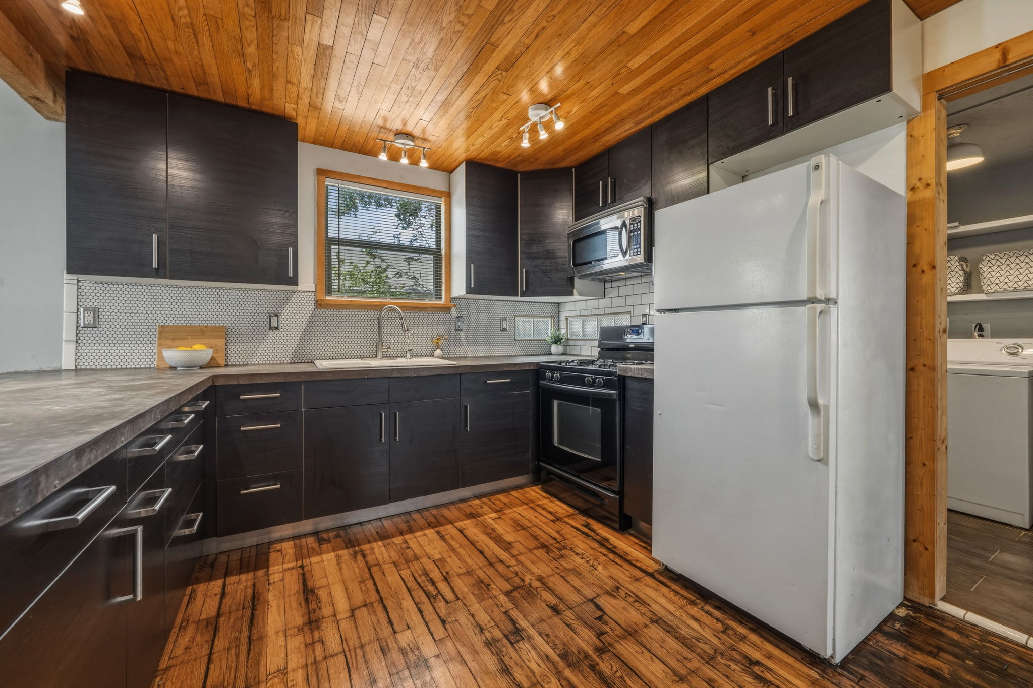 4806 Santa Anna Street Austin, TX 78721 - Photo 8 of 35 a kitchen with stainless steel appliances a refrigerator and a sink
