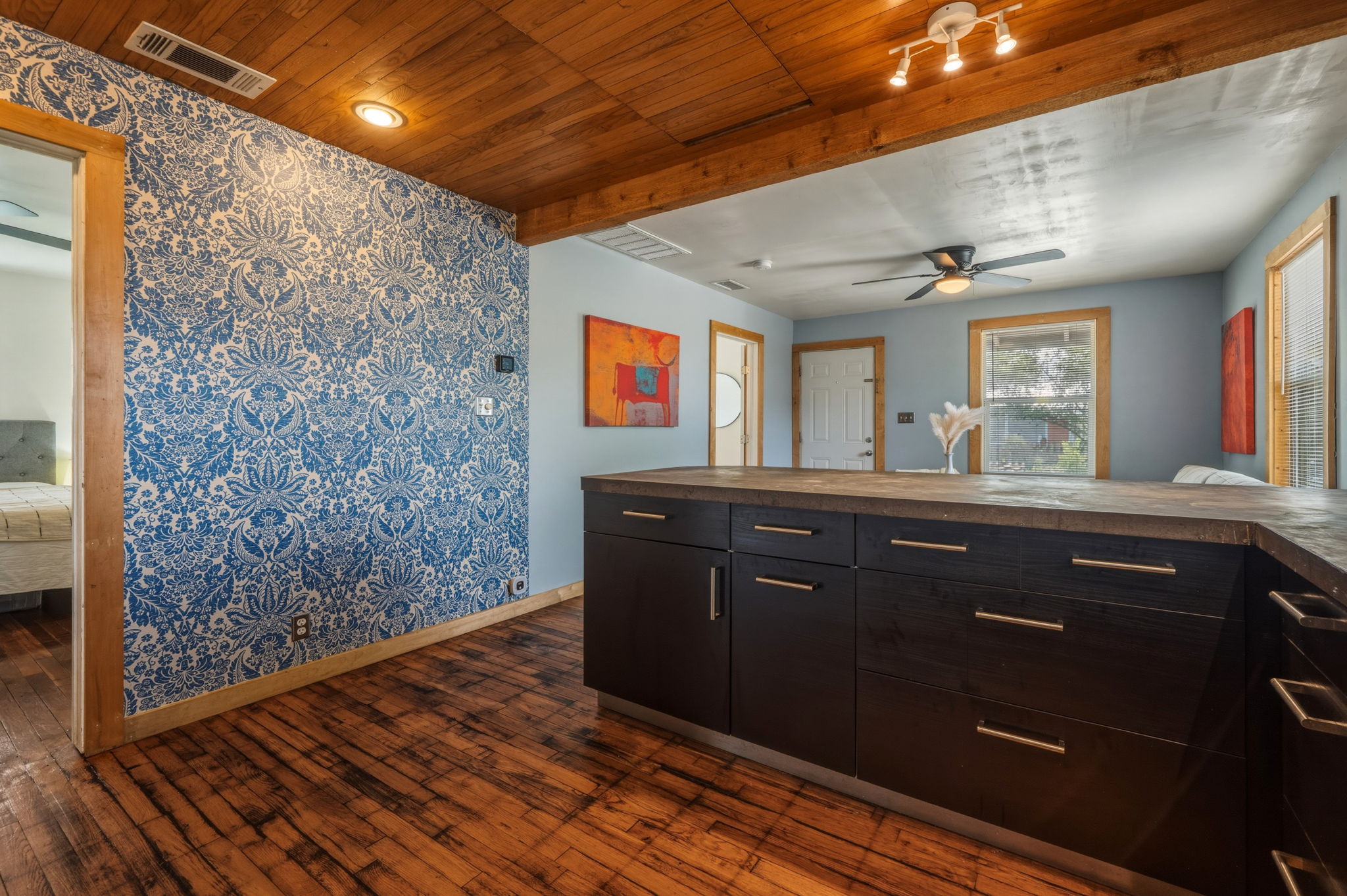 4806 Santa Anna Street Austin, TX 78721 - Photo 9 of 35 Kitchen featuring concrete counters, gas stove, microwave, freestanding refrigerator, and wood flooring & ceiling