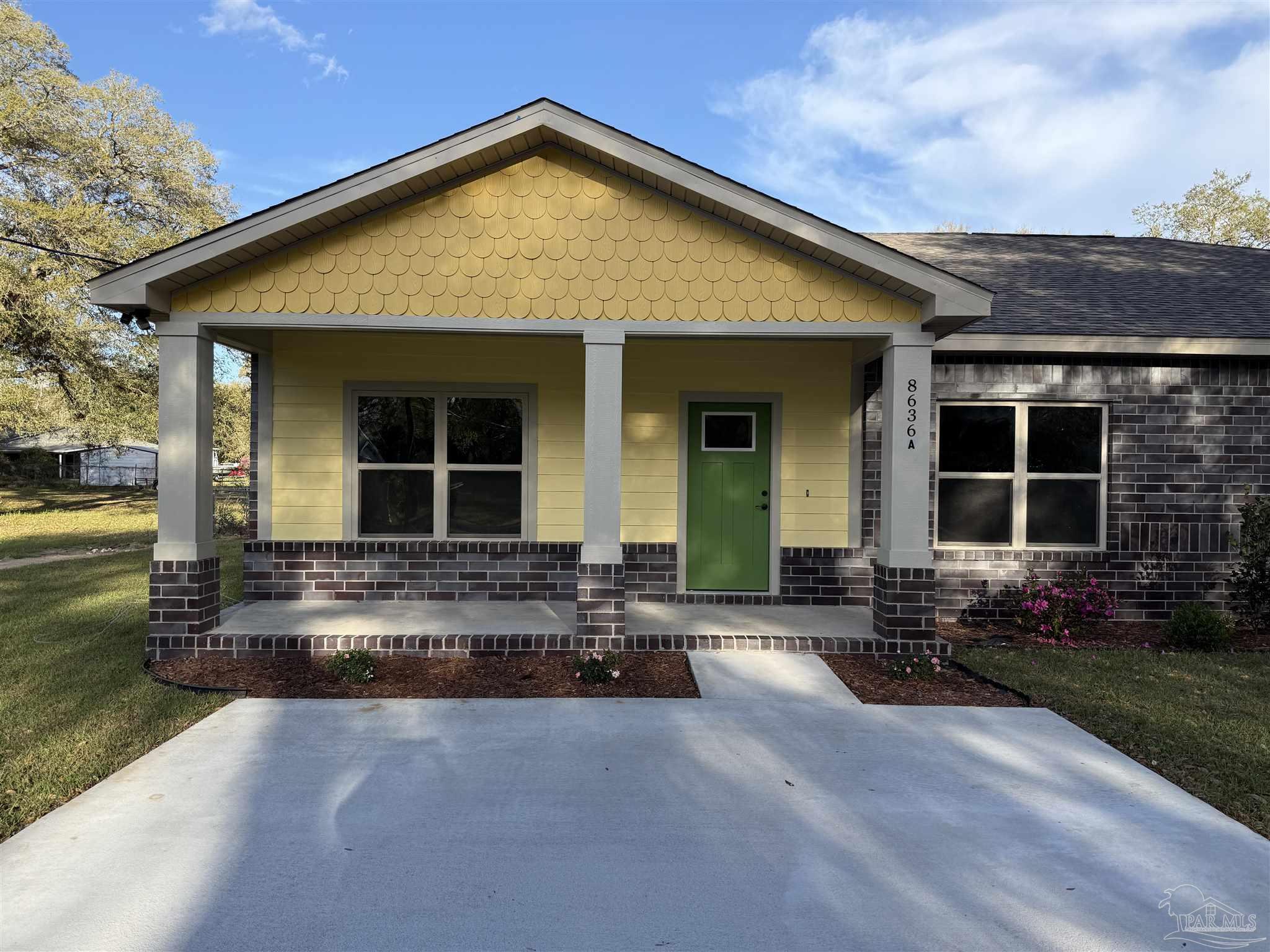 8636 Messick Street, Unit A Pensacola, FL 32534 - Photo 1 of 13 a front view of a house with a yard