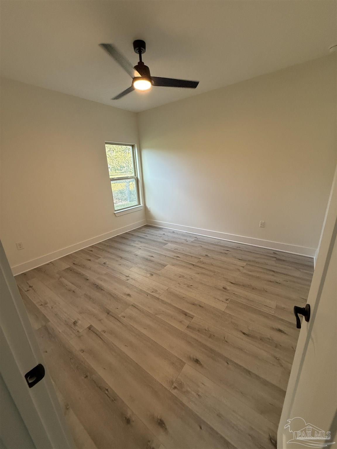 8636 Messick Street, Unit A Pensacola, FL 32534 - Photo 11 of 13 wooden floor in an empty room
