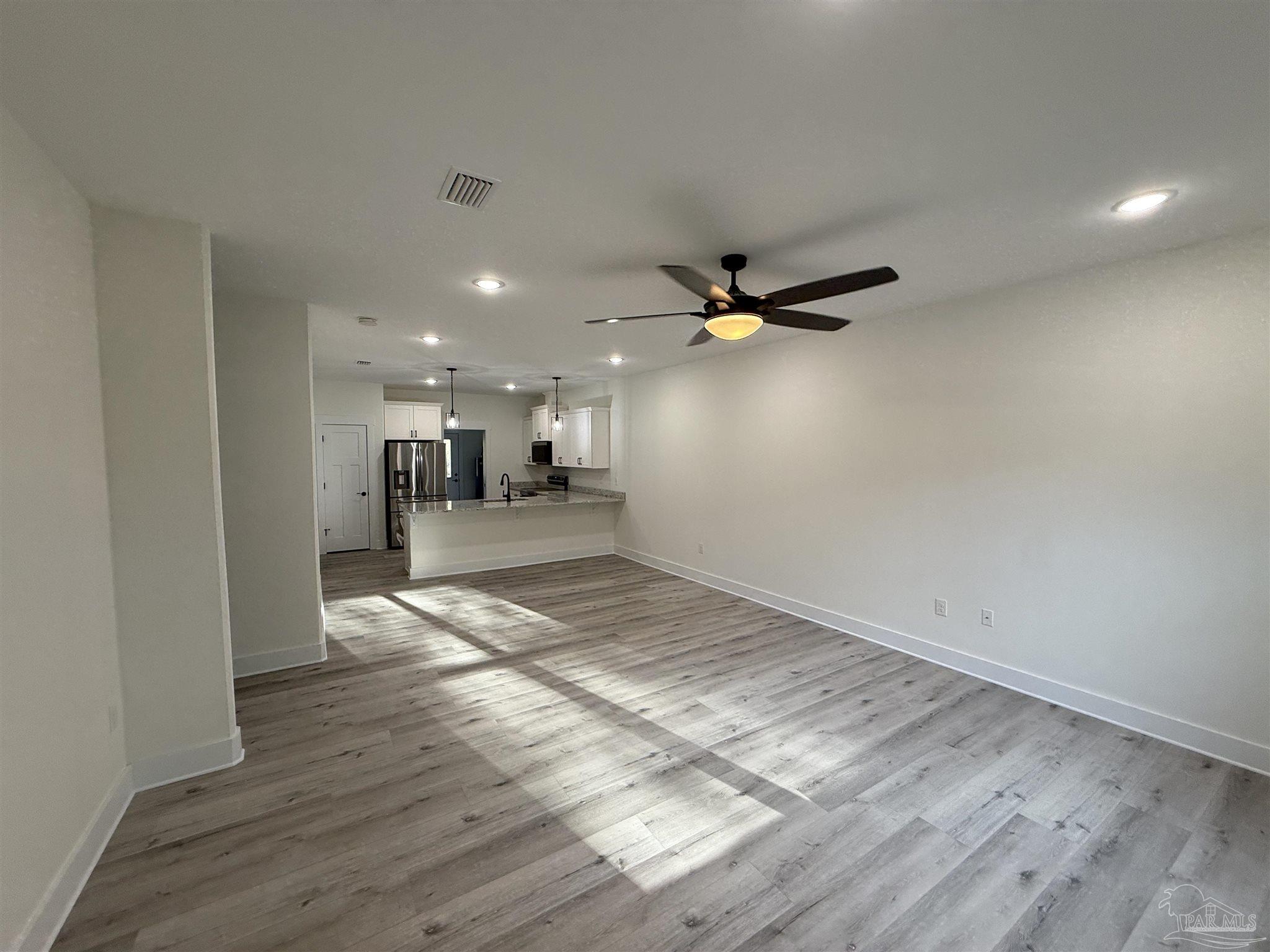 8636 Messick Street, Unit A Pensacola, FL 32534 - Photo 2 of 13 a view of empty room with wooden floor