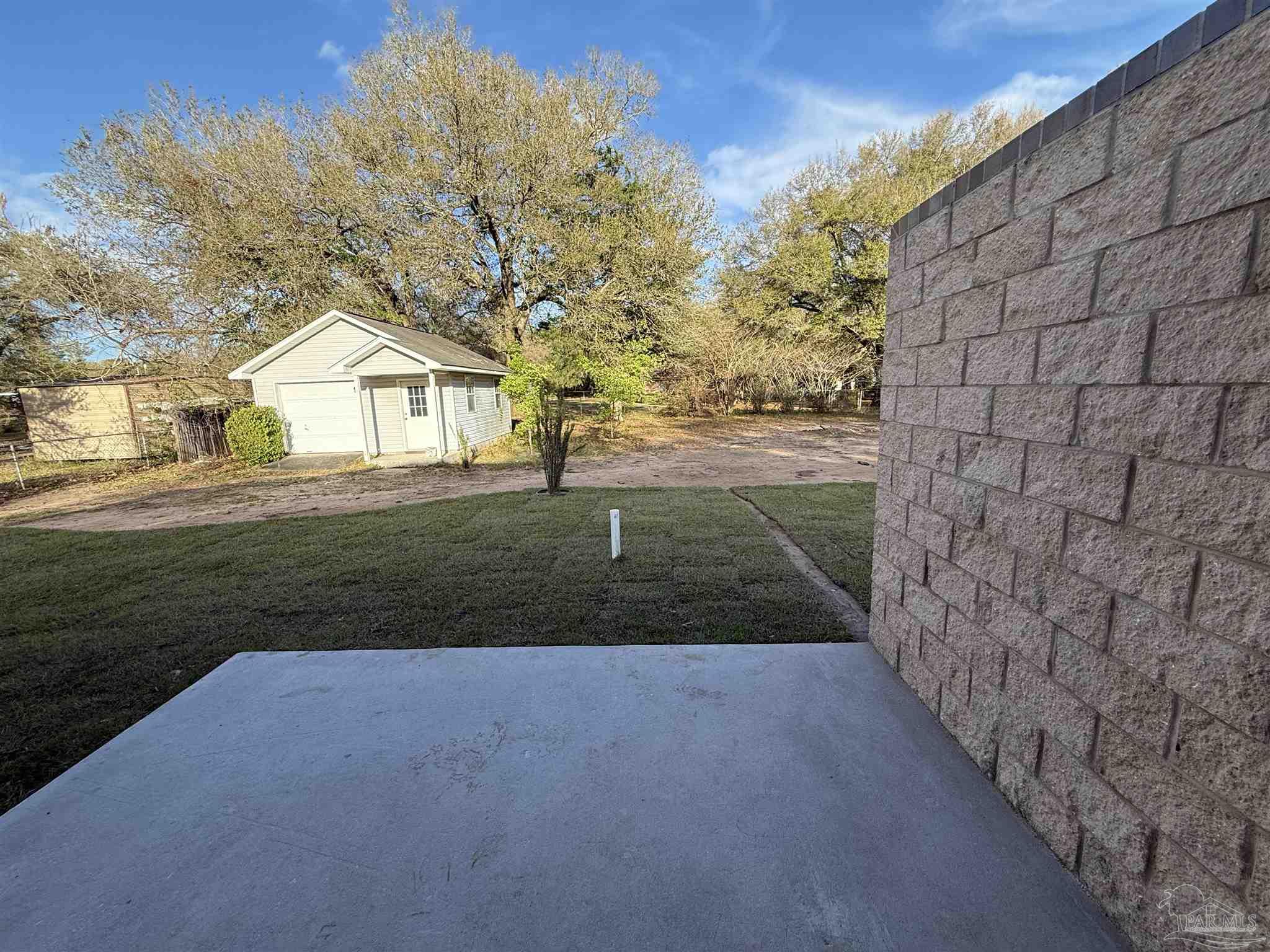 8636 Messick Street, Unit A Pensacola, FL 32534 - Photo 6 of 13 a view of yard in front of house with trees