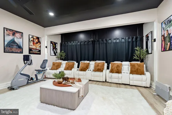 a living room with furniture kitchen view and a large window