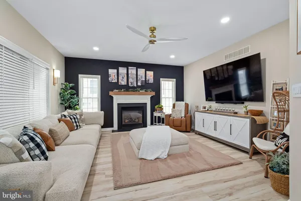 a living room with furniture fireplace and flat screen tv