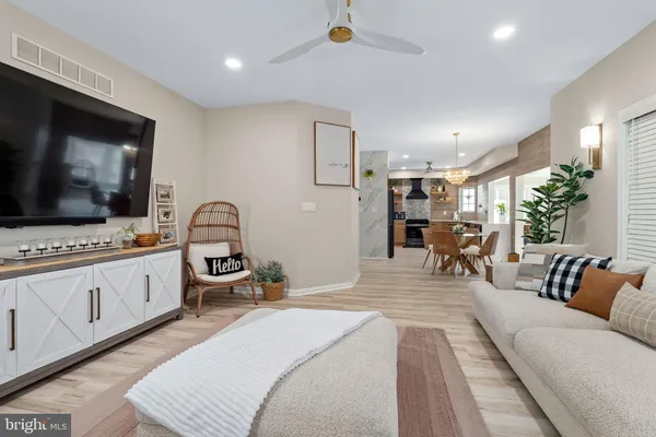 a large bedroom with a bed and a flat screen tv