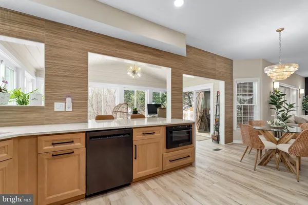 a large kitchen with cabinets and wooden floor