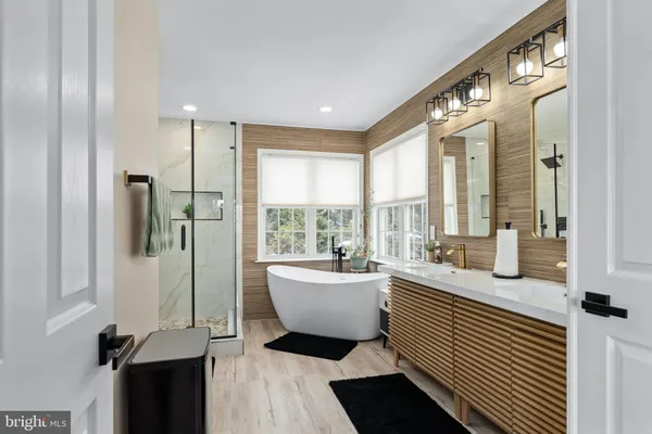 a bathroom with a granite countertop bathtub shower and toilet