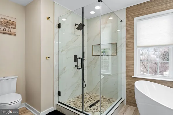 a bathroom with a double vanity sink a mirror and a bathtub