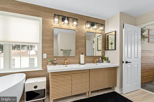 a white bath tub sitting in front of a window