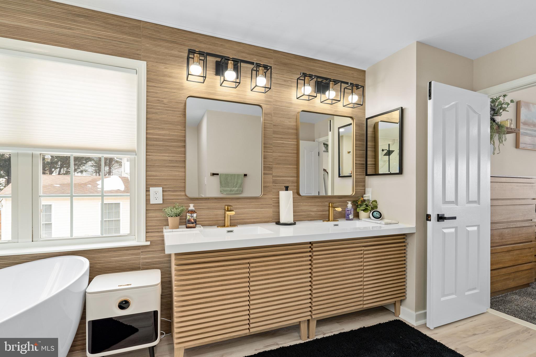 303 Beacon Point Drive Perryville, MD 21903 - Photo 39 of 43 a bathroom with a double vanity sink a mirror and a bathtub