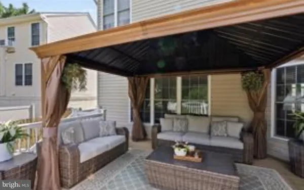 a outdoor living space with patio furniture and a potted plant