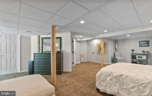 a bedroom with a bed and a television