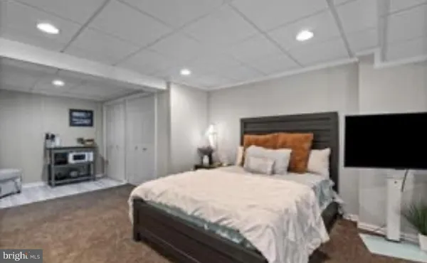 a bedroom with double bed and a large window