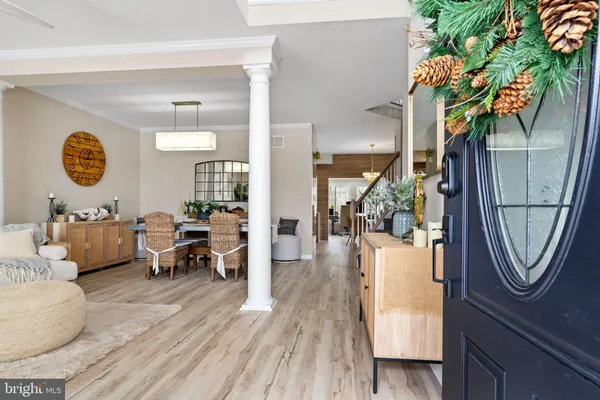 a living room with furniture a table and wooden floor