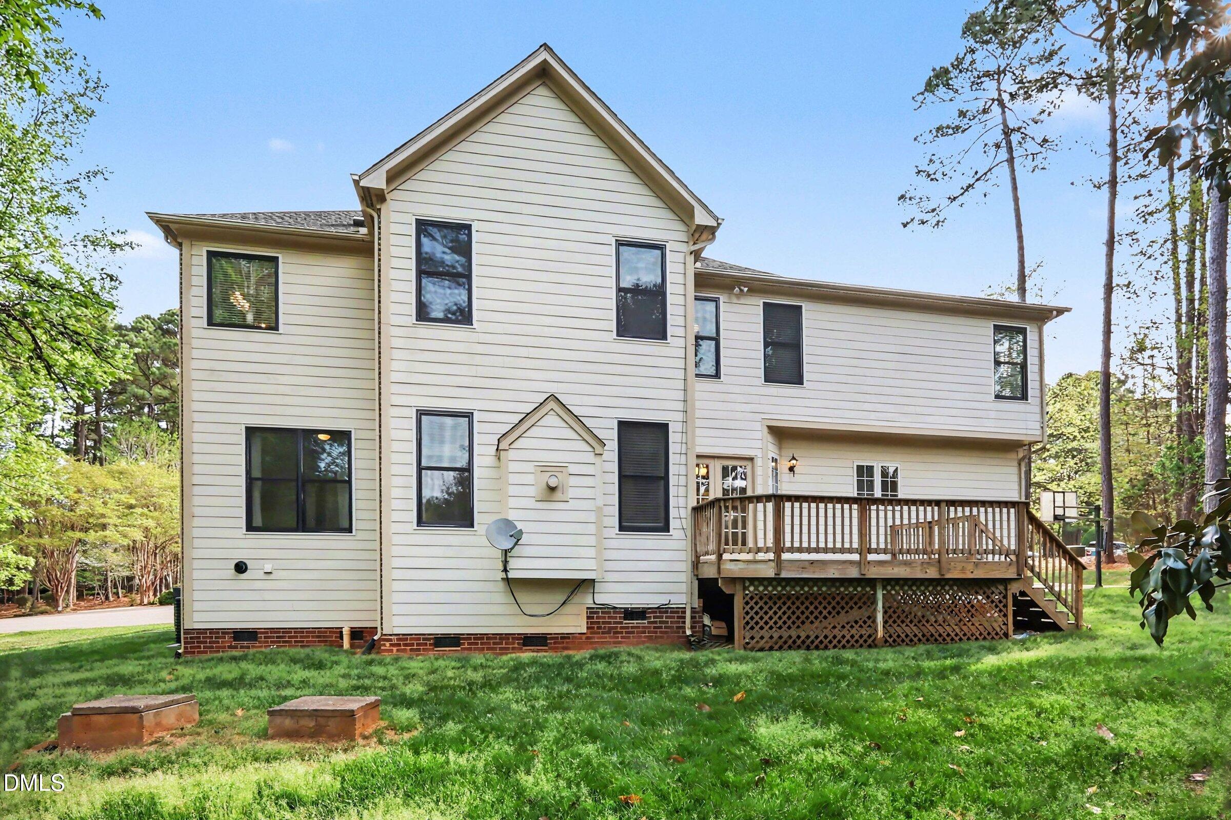 1001 Denfield Court Raleigh, NC 27615 - Photo 32 of 44 a view of a house with a yard and a large tree