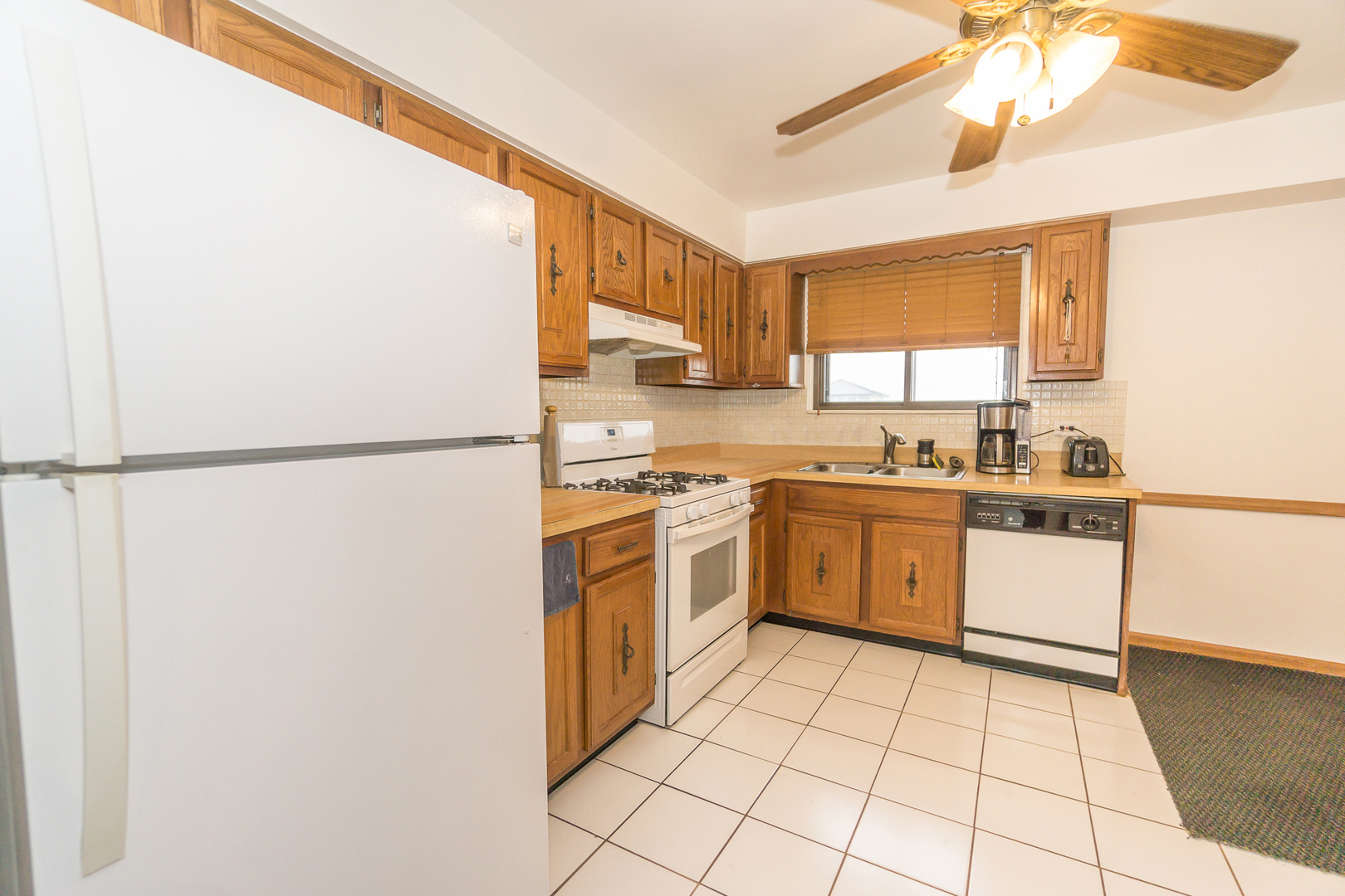 922 West Irving Park Road, Unit 303 Bensenville, IL 60106 - Photo 5 of 16 a kitchen with a white cabinets and white appliances