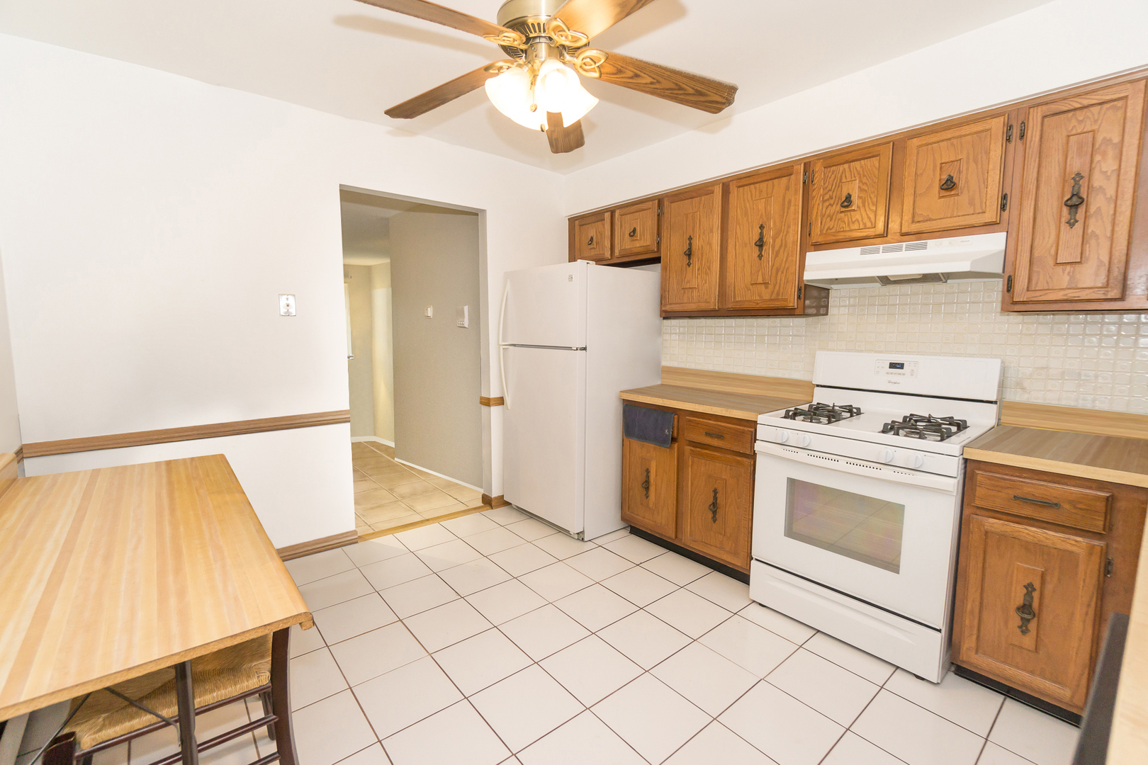 922 West Irving Park Road, Unit 303 Bensenville, IL 60106 - Photo 6 of 16 a kitchen with a stove cabinets and a refrigerator