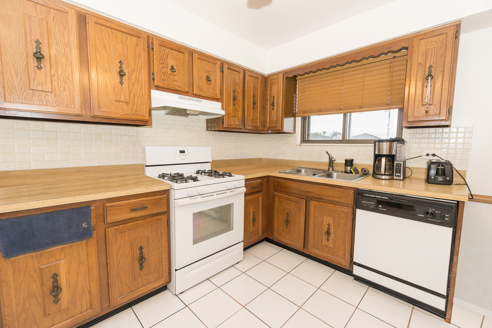 922 West Irving Park Road, Unit 303 Bensenville, IL 60106 - Photo 7 of 16 a kitchen with white cabinets sink and white appliances