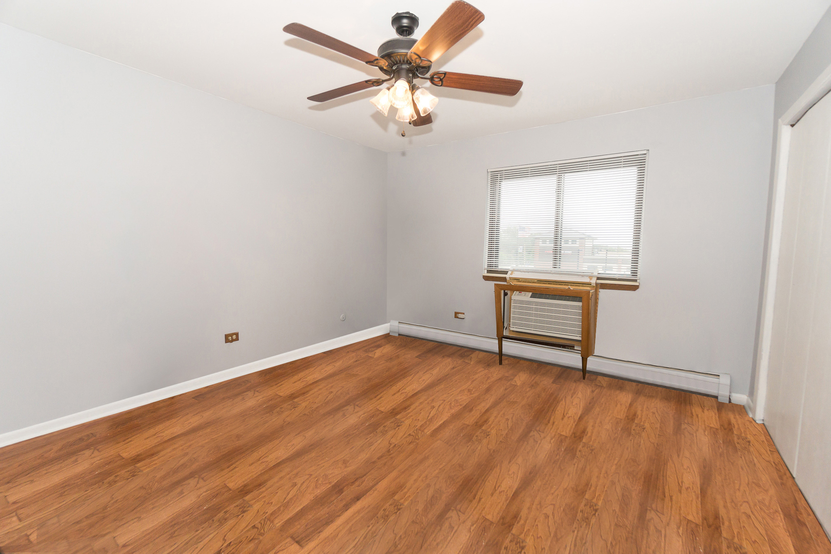 922 West Irving Park Road, Unit 303 Bensenville, IL 60106 - Photo 8 of 16 wooden floor in an empty room with a window