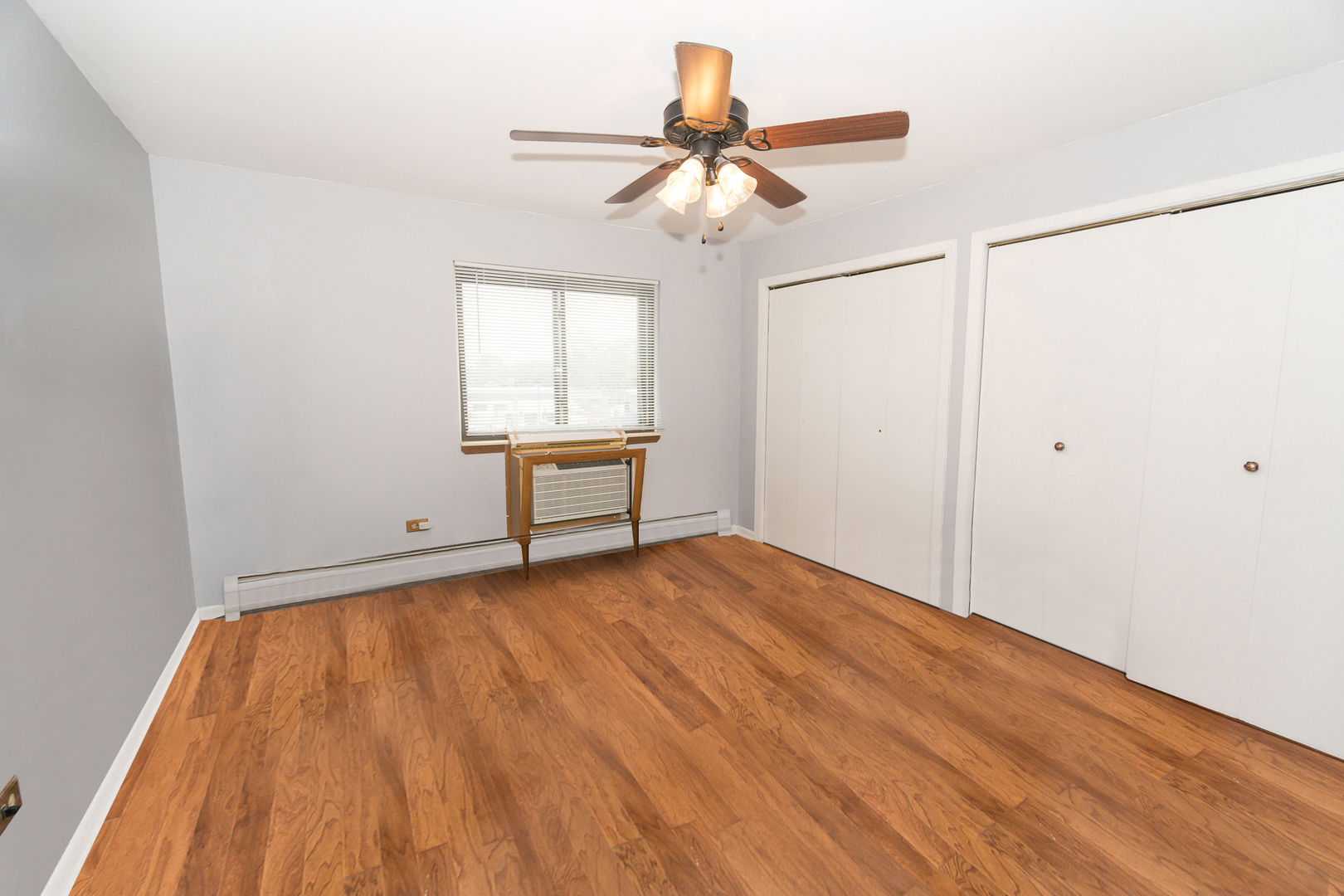 922 West Irving Park Road, Unit 303 Bensenville, IL 60106 - Photo 9 of 16 wooden floor in an empty room with a window