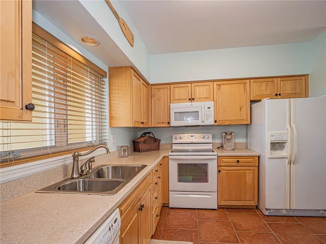 a kitchen with stainless steel appliances a stove a sink and a refrigerator